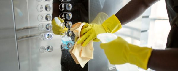 Hands cleaning elevator buttons - www.freepik.com